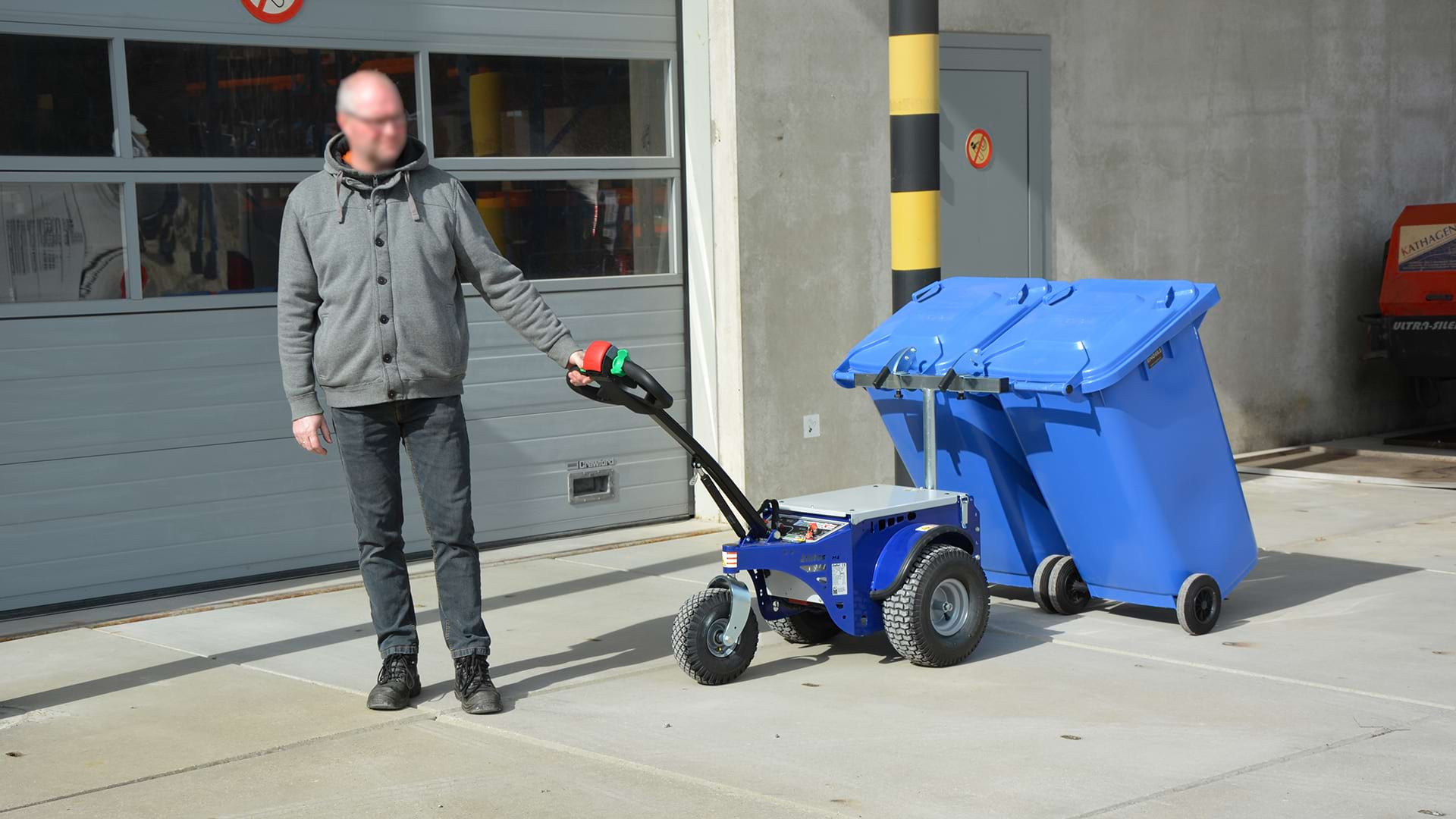 Pedestrian operated Zallys tug connected to two wheelie bins